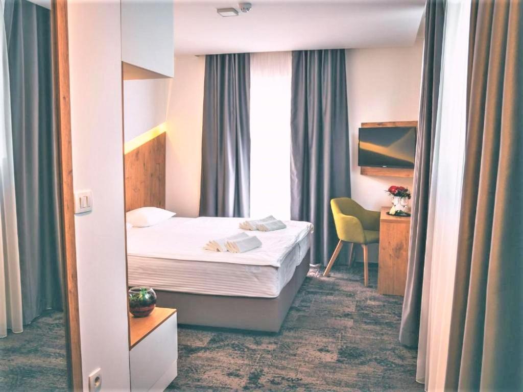Postel nebo postele na pokoji v ubytování Orange Hotel