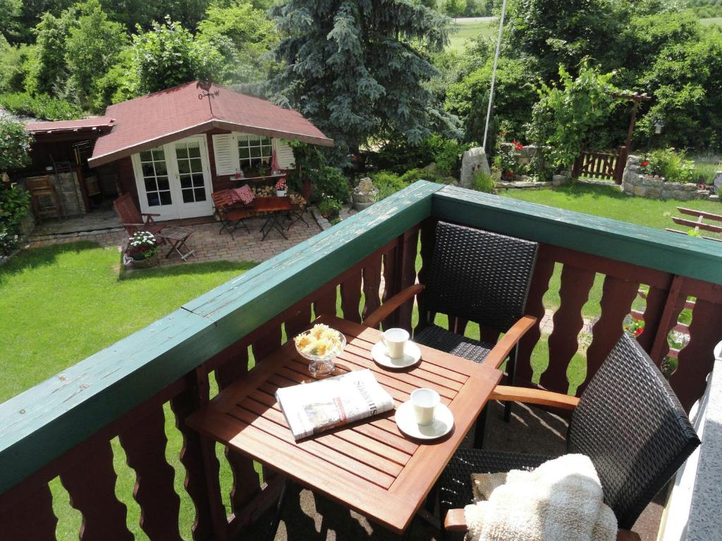 a wooden table with two chairs on a balcony at Picturesque Mansion with Balcony Grill Garden and Heating in Zeil