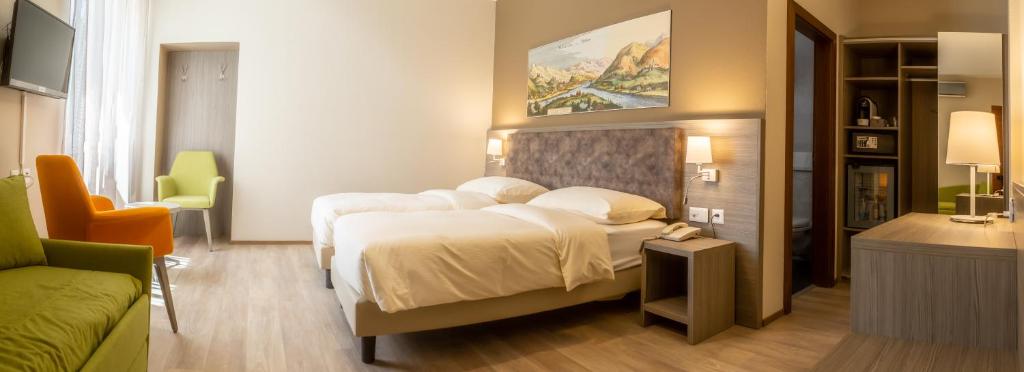 Postel nebo postele na pokoji v ubytování Hotel Unione