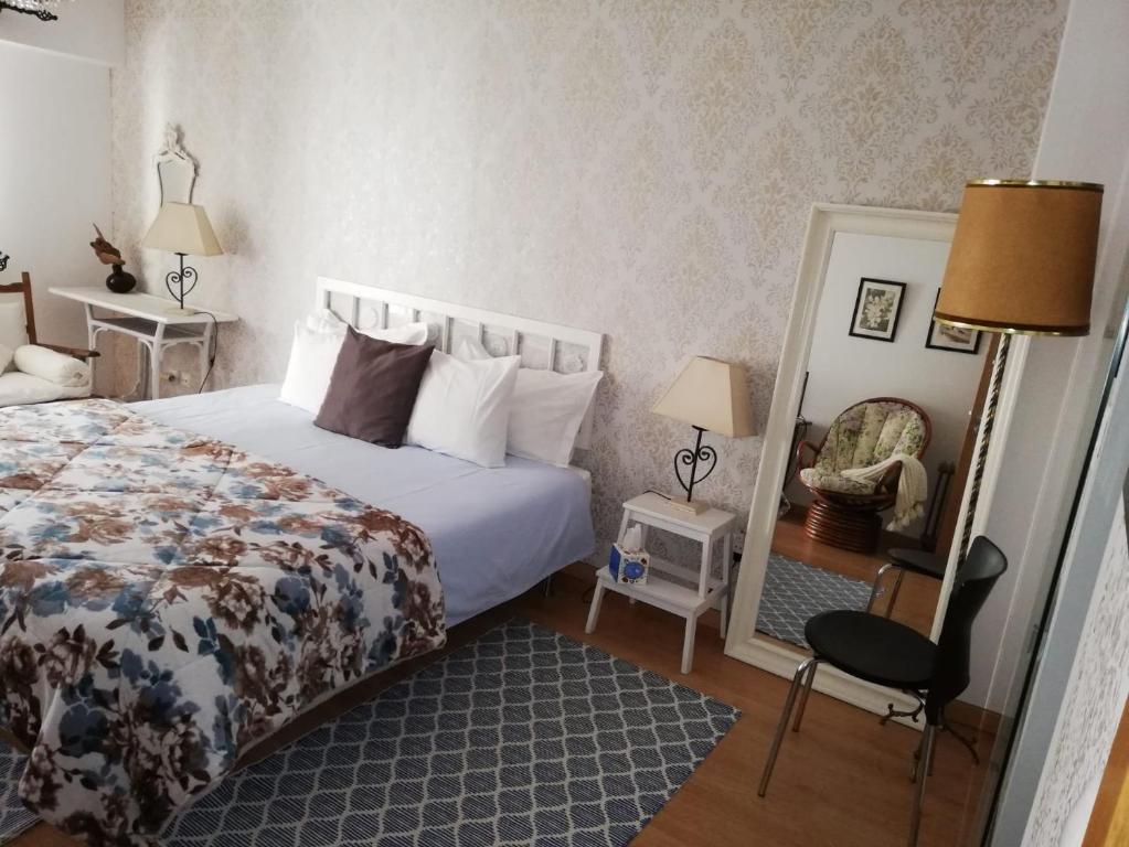 a bedroom with a bed and a mirror at Quinta Nova Guest Room in Odivelas