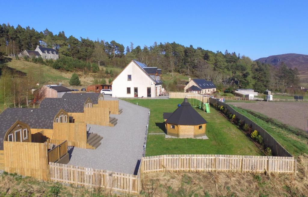 an aerial view of a farm with a house at Tigh an Each B&B & Laggan Glamping in Newtonmore