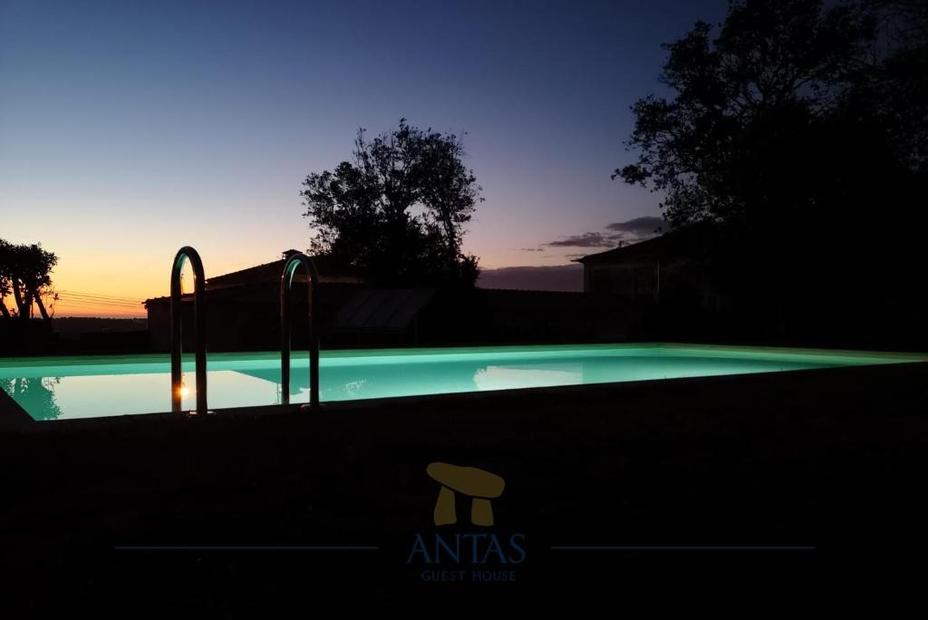 two people standing in front of a pool of water at Antas Guest House in Esposende