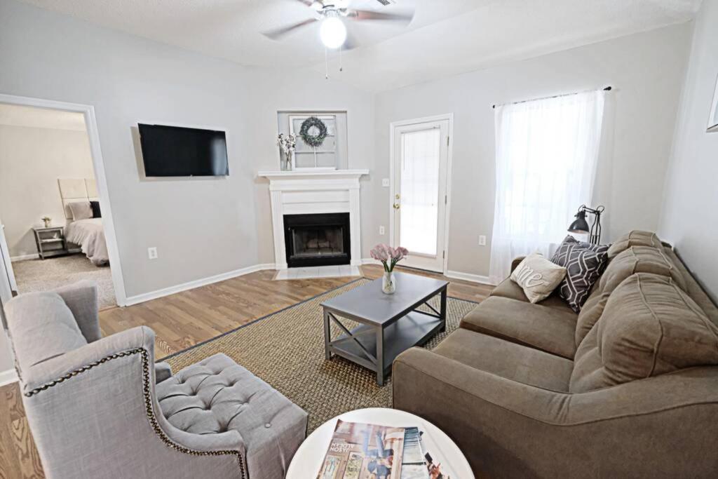 a living room with a couch and a fireplace at Fresh Farmhaus by Design in Augusta in Augusta