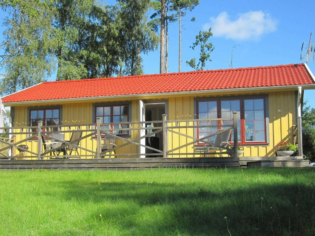 a small yellow house with a red roof at 4 person holiday home in H CKSVIK in Håcksvik