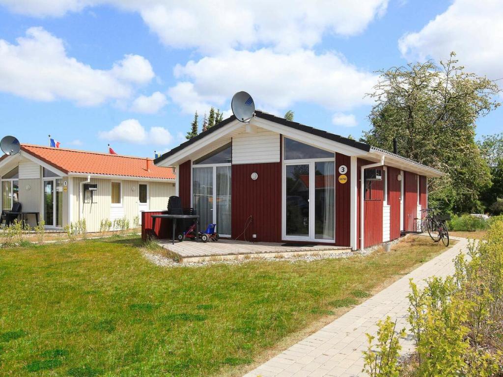 ein kleines Haus mit Rot und Weiß in der Unterkunft Two-Bedroom Holiday home in Grömitz 11 in Grömitz