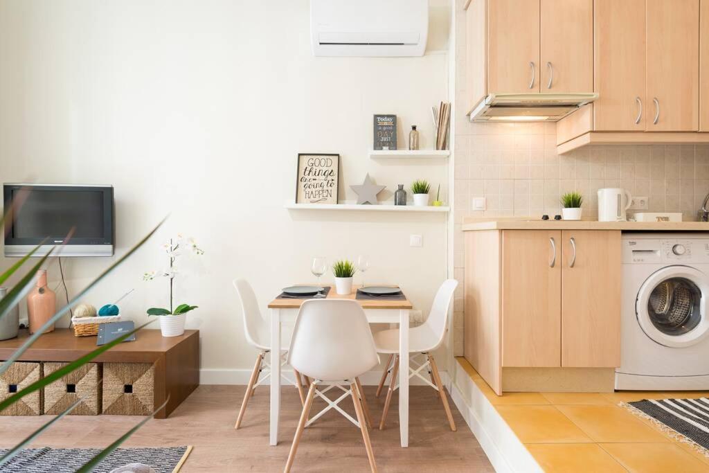 a kitchen with a table and a washing machine at TGH Málaga centro histórico - Calle Alamos in Málaga