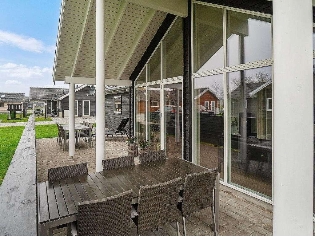 a patio with a table and chairs on a house at Holiday home Kappeln XVII in Kappeln