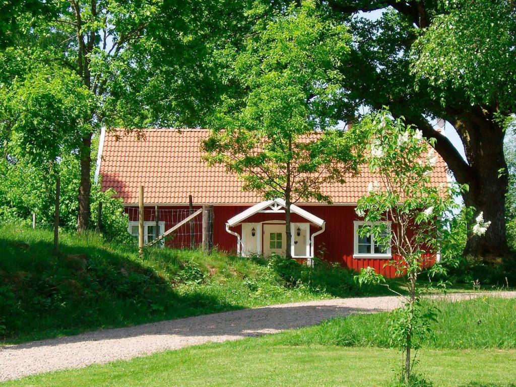 a red house with a red roof at 6 person holiday home in H CKSVIK in Håcksvik
