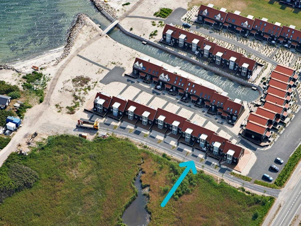 an aerial view of a marina with a blue arrow at Holiday Home Strandengen in Juelsminde