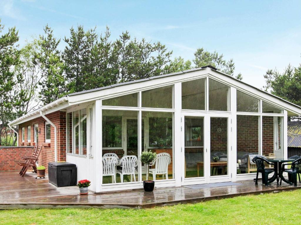 an orangery with glass doors on a deck at 6 person holiday home in Jerup in Jerup