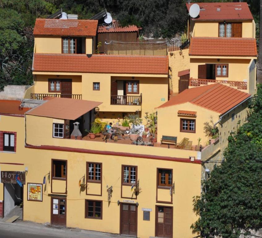 an overhead view of a yellow building with red roofs at Hotel Rural Villa de Hermigua in Hermigua