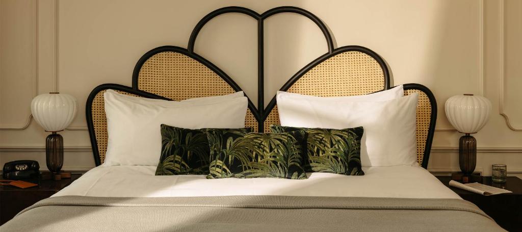 a bed with a large headboard and some pillows at The Hoxton, Downtown LA in Los Angeles