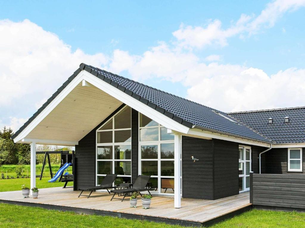 Hadsundにある8 person holiday home in Hadsundの縞模様屋根の黒い家