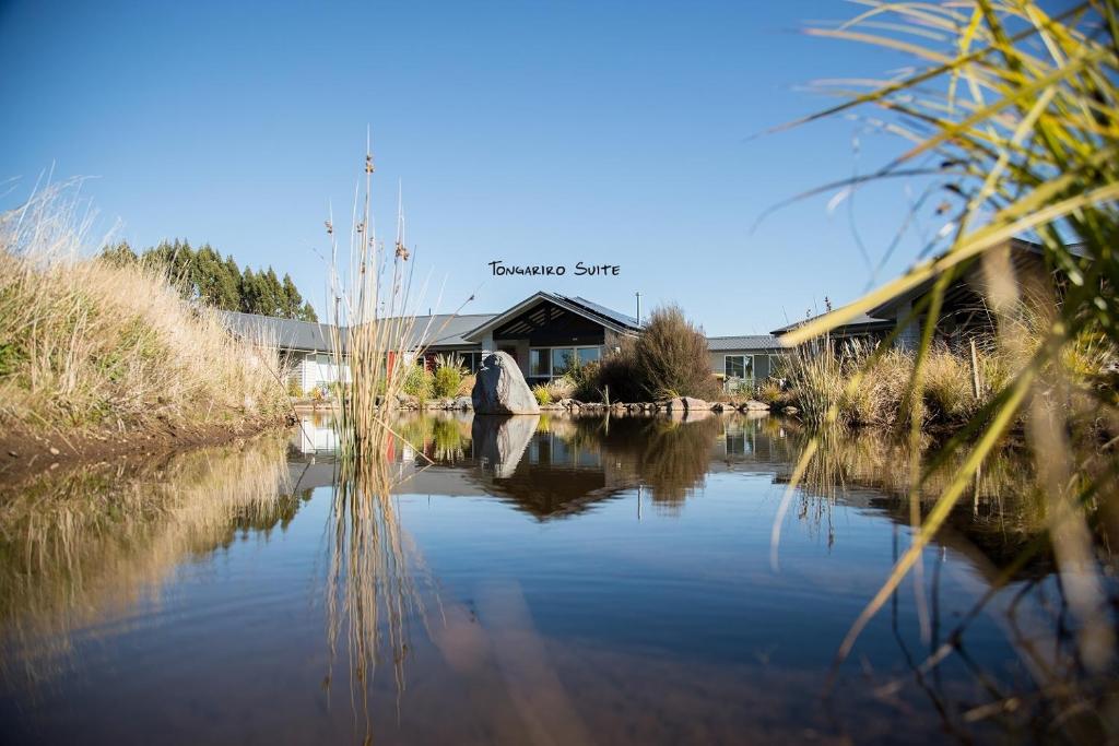 a view of a building with a river in front at Tongariro Suites in Ohakune
