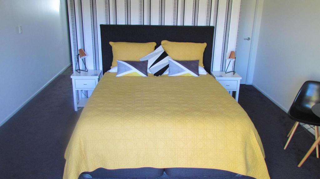 A bed or beds in a room at Tongariro Suites
