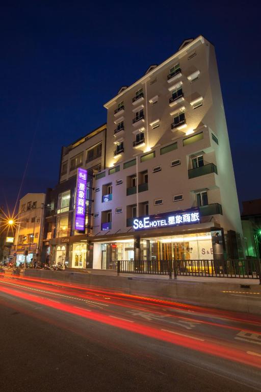 a building with a sign on it at night at S&amp;E Hotel in Tainan