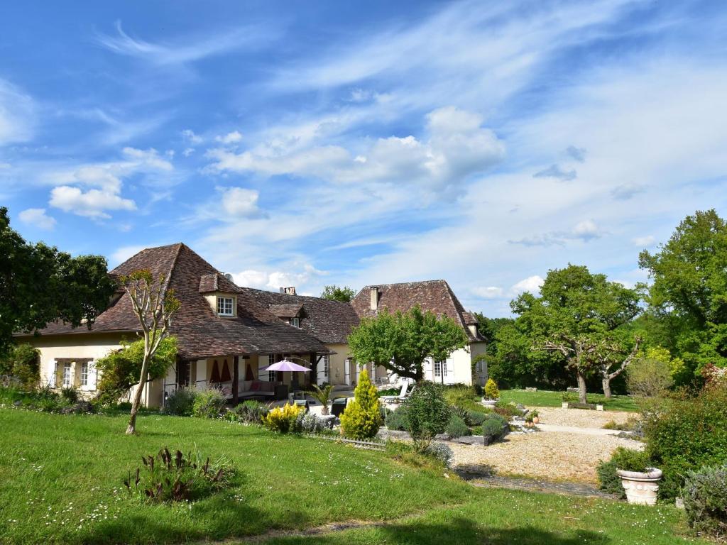 une maison ancienne avec un jardin au premier plan dans l'établissement Luxurious Mansion in Aquitaine with Swimming Pool, à Port-Sainte-Foy-et-Ponchapt