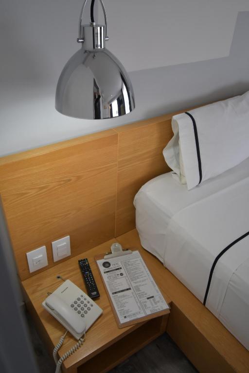 Postel nebo postele na pokoji v ubytování Hotel Perla Central