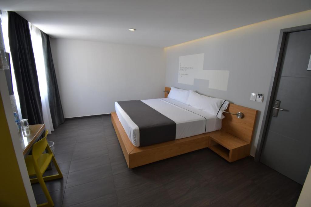 Postel nebo postele na pokoji v ubytování Hotel Perla Central