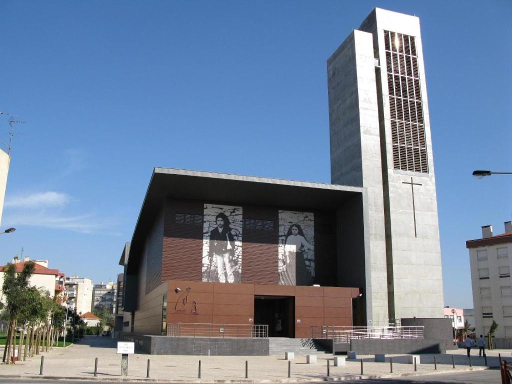 a large building with a clock tower in a city at 2Bed 15km Lisbon - Wifi, Ac, Parking in Arsena