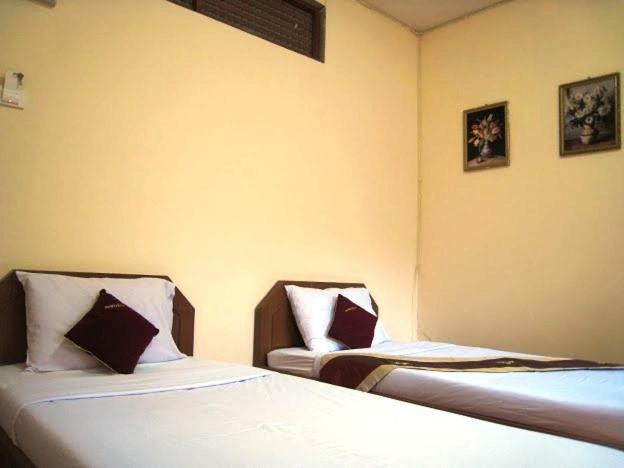 Кровать или кровати в номере Choktawee Mansion Lampang