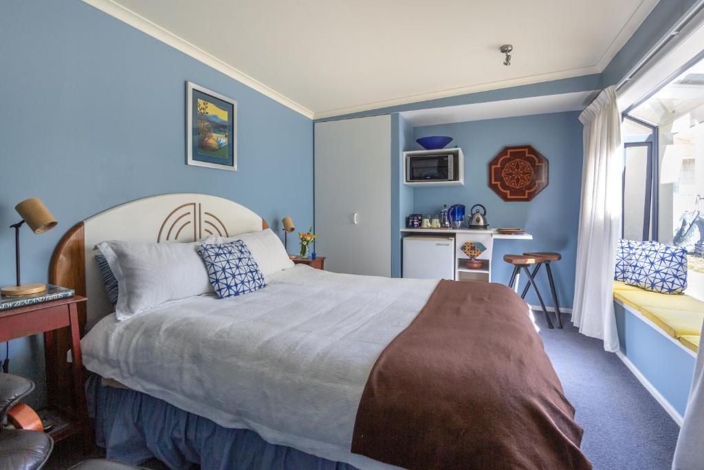 um quarto com paredes azuis e uma cama em Blue moon em Collingwood