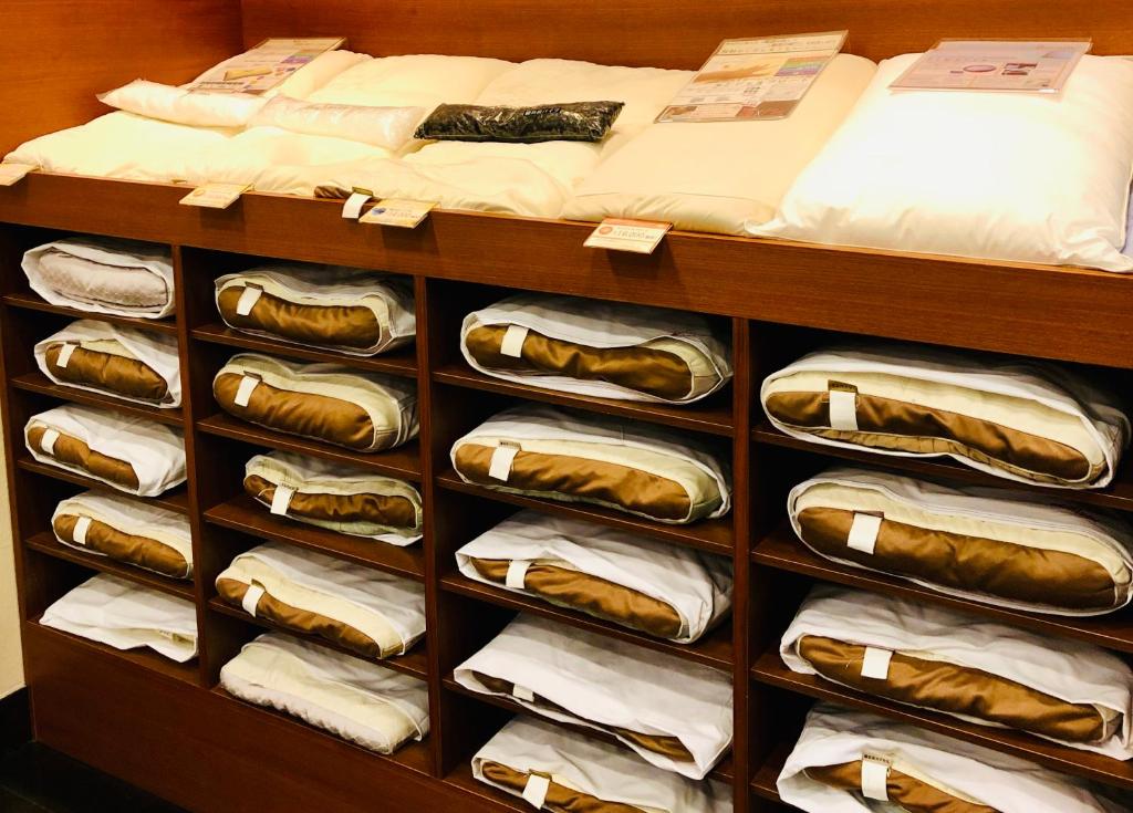 a closet filled with lots of hot dogs and towels at Kadoya Hotel in Tokyo