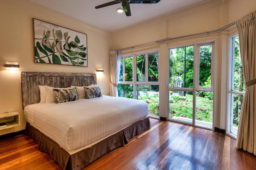 una camera con letto e ampie finestre di Sutera Sanctuary Lodges At Kinabalu Park a Kampong Kundassan