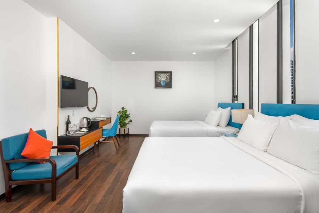 Postel nebo postele na pokoji v ubytování Platinum Danang Hotel