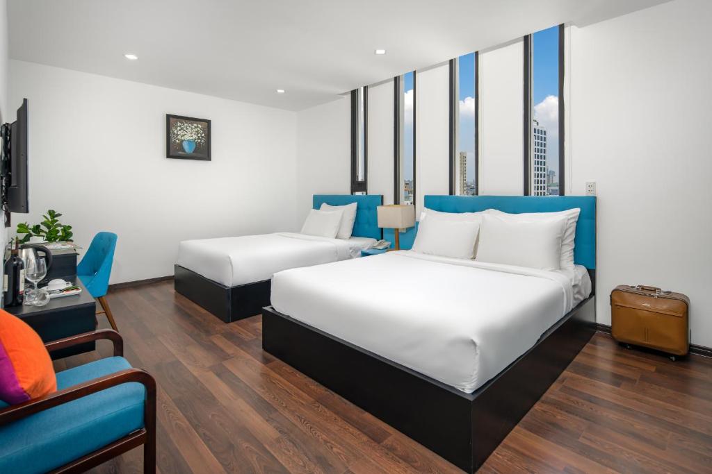 Postel nebo postele na pokoji v ubytování Platinum Danang Hotel