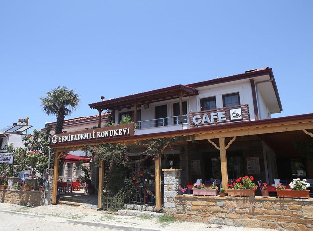 a building with asale sign on it on a street at Yeni Bademli Konuk Evi in Gokceada Town