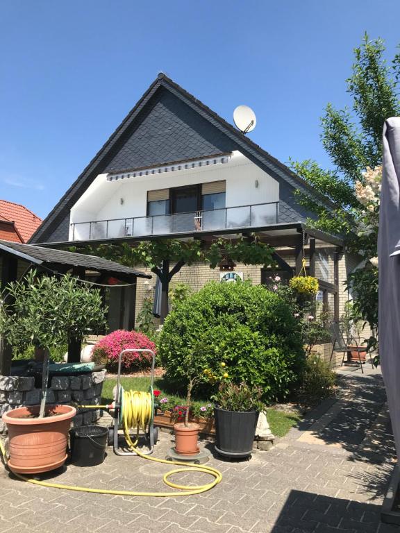 uma casa com muitas plantas à frente dela em Ferienwohnung Poczewski em Kevelaer