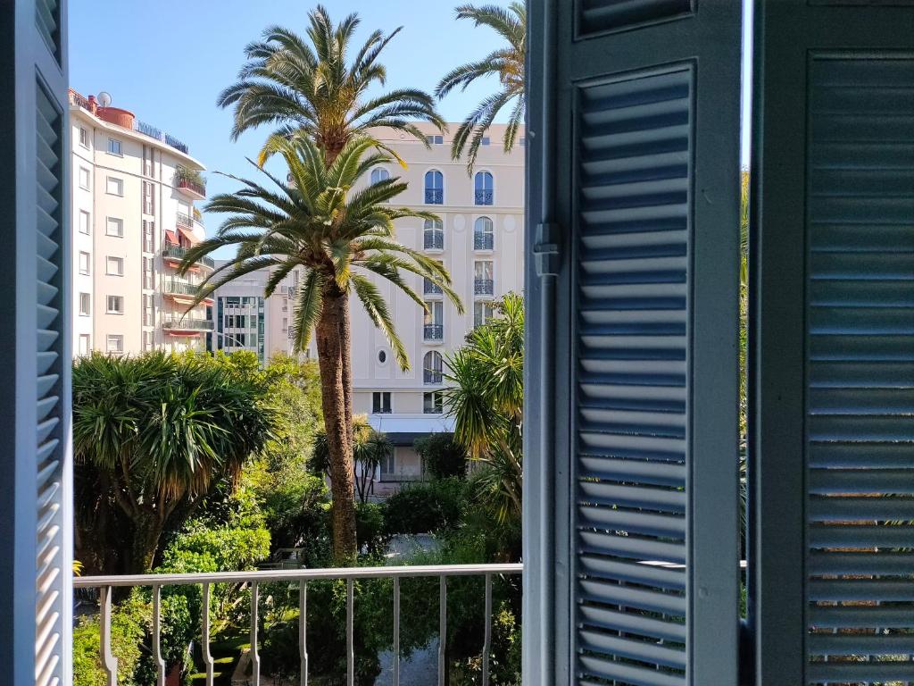 a view from a window of a building with palm trees at Hôtel de Provence in Cannes