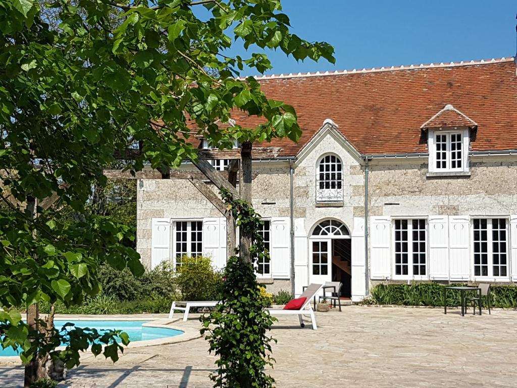 a building with a pool in front of it at la blanchetière in Francueil