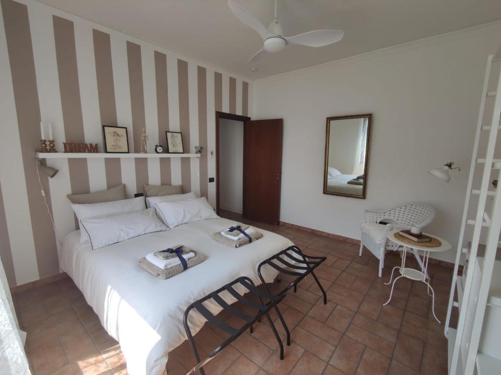 a bedroom with a bed and a table and chairs at Lacasaceleste in Osimo
