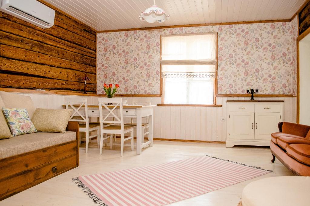 a living room with a couch and a table at Wiedemanni Apartment in Haapsalu