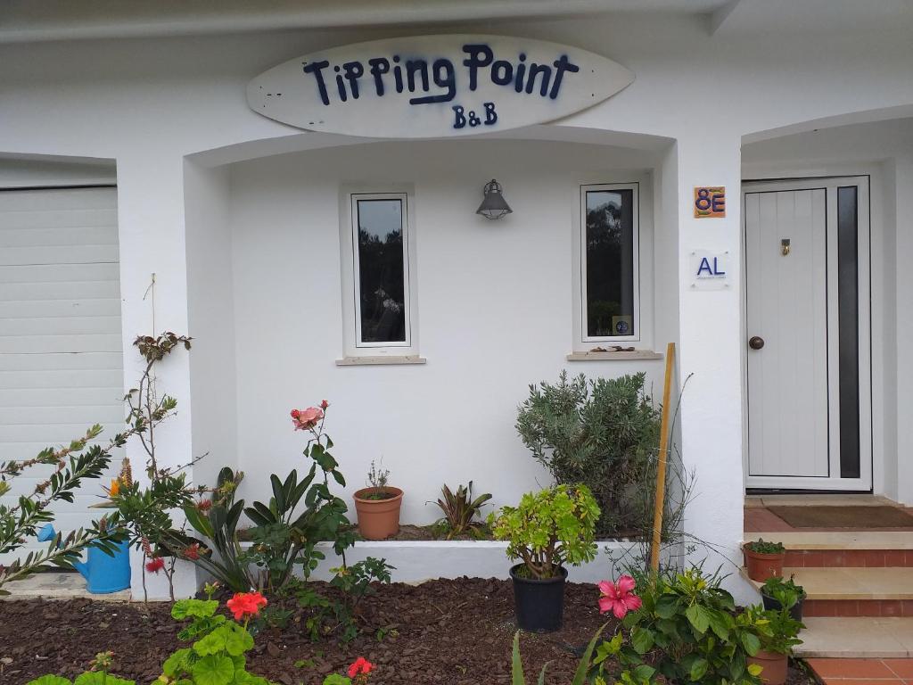 a house that has a sign in front of it at Tipping Point North Beach Nazare in Nazaré