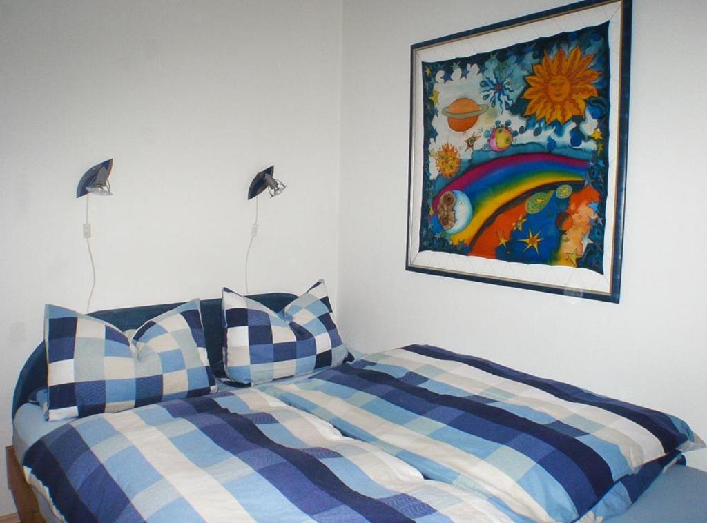 a bedroom with a bed and a painting on the wall at Ferienwohnung Ilka Plank in Füssen