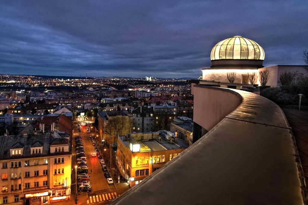 a view of a city at night from a building at Don Giovanni Hotel Prague - Great Hotels of The World in Prague