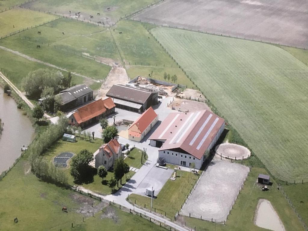 an aerial view of a farm with a building at Holiday Home Koolhof in Nieuwpoort