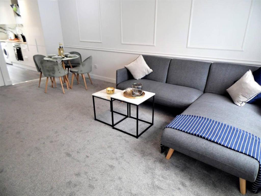 a living room with a couch and a table at Black Cart House in Johnstone