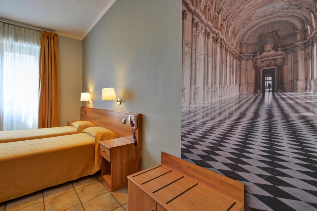 Postel nebo postele na pokoji v ubytování Astor Hotel