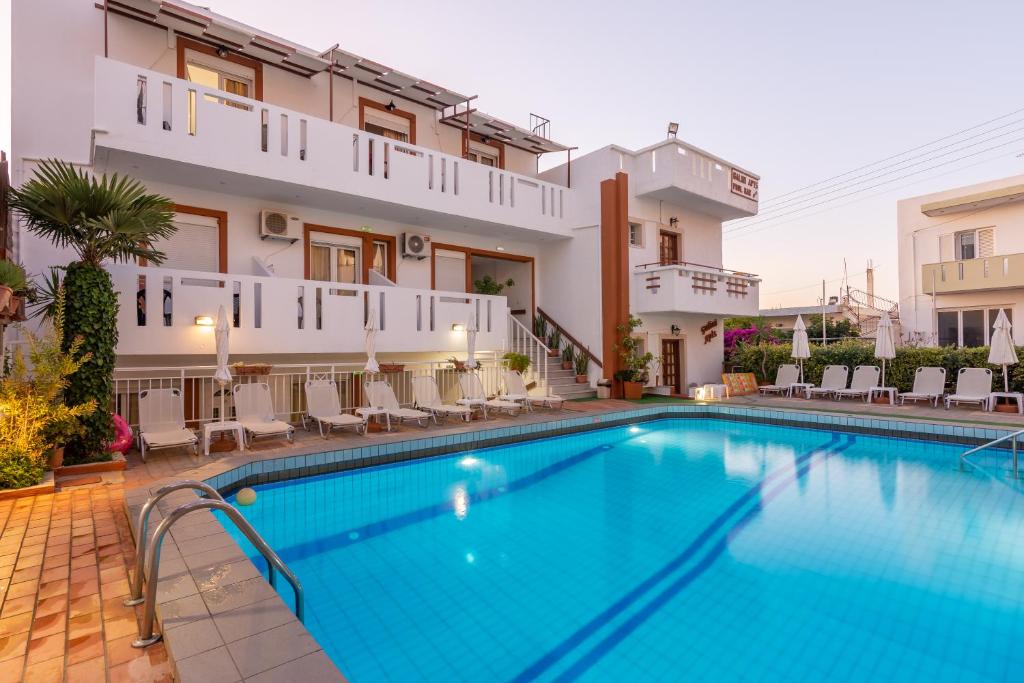 a swimming pool in front of a building at Galini Apartments in Hersonissos