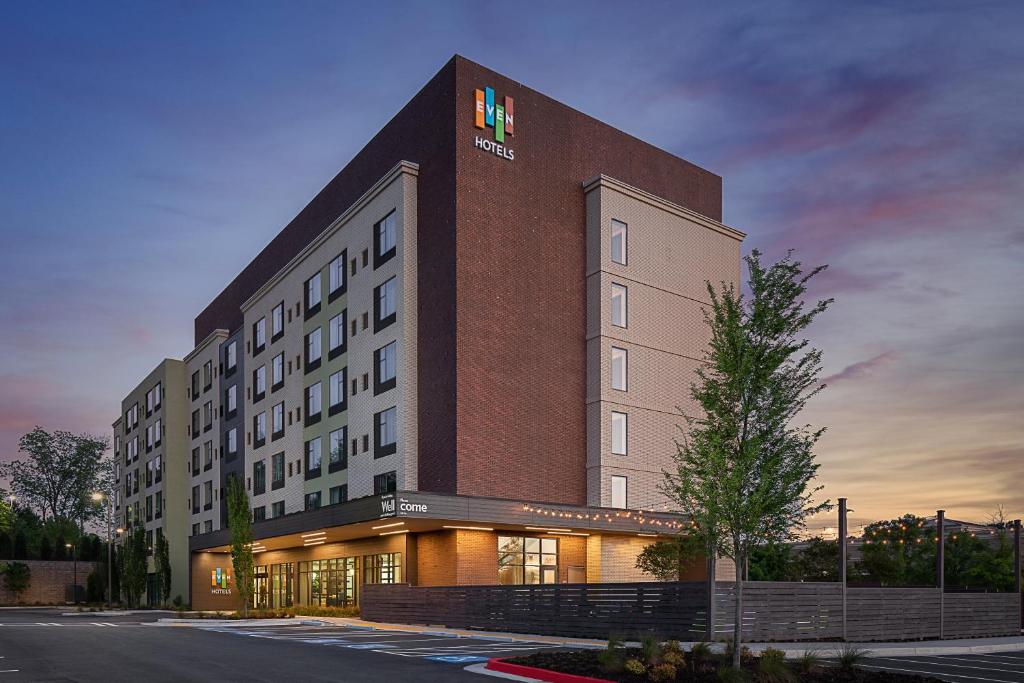 a rendering of a hotel building at dusk at EVEN Hotel Alpharetta - Avalon Area, an IHG Hotel in Alpharetta