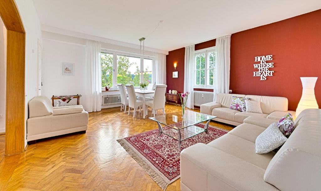 a living room with a white couch and a table at Ferienwohnung Panoramablick Freudenstadt in Freudenstadt