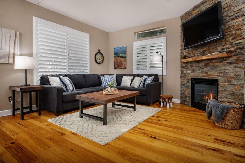 a living room with a couch and a fireplace at Beaverton Creek Cottage in Beaverton