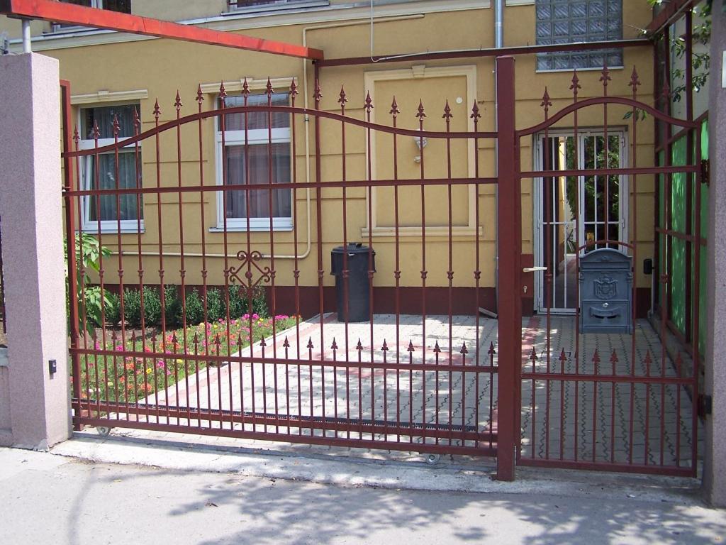 an iron gate in front of a house at Akacia Apartment - FREE PARKING INSIDE OUTSIDE 2 bedrooms garden next to centre in Budapest