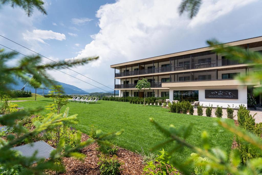 a building with a lawn in front of it at K1 Mountain Chalet - Luxury Apartements in Brunico