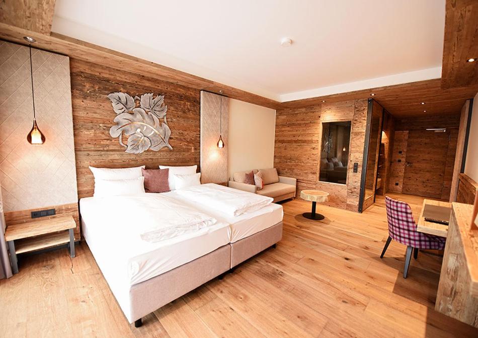 a bedroom with a large bed and a living room at Spessart-Lodge in Weibersbrunn