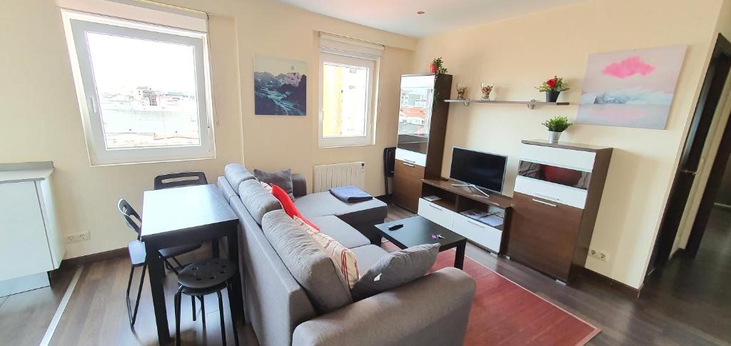a living room with a couch and a table at Acogedor apartamento en Ronda Outeiro 210 in A Coruña
